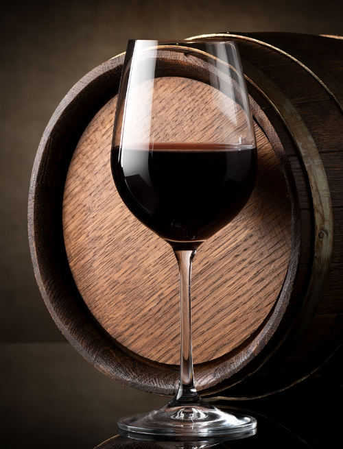 Newcastle Wine Week glass of red wine in front of a barrel
