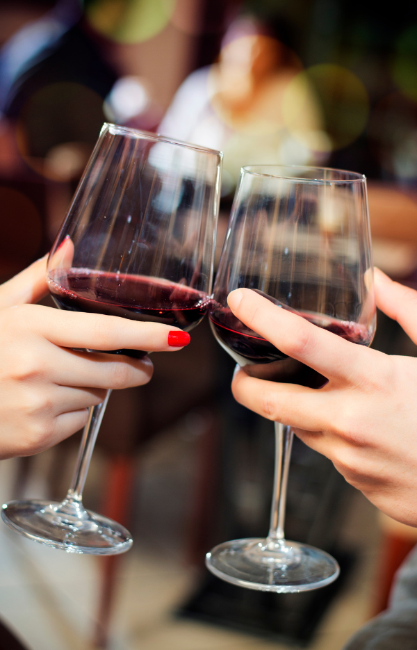 Newcastle Wine Week a man and womans hand cheersing wine glasses